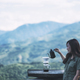 An asian woman making drip coffee with a beautiful green mountain and nature in background - PhotoDune Item for Sale