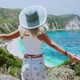 Woman with Sun Hat Spreading Arms in Front of Beautiful Seascape on Kefalonia Island. Blonde Female - VideoHive Item for Sale