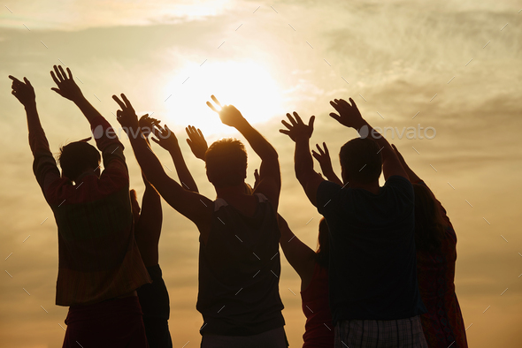 Hands up silhouette in sunny sky background.
