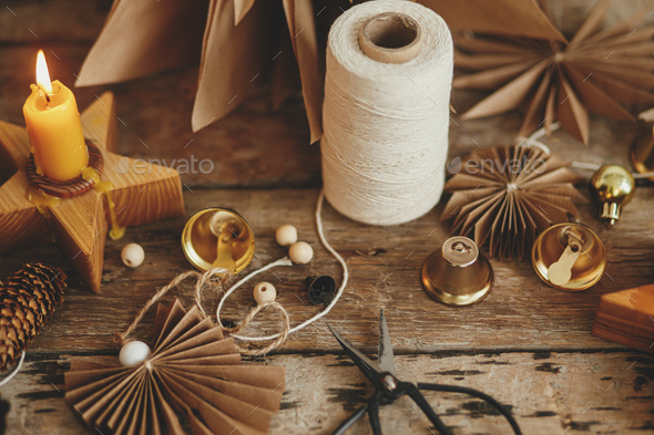 Christmas angel, stars, pine cones, candle, thread, scissors on rustic  wood. Handmade scandi decor Stock Photo by Sonyachny
