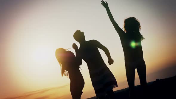 Group of Happy Young People Enjoying Summer Sunset