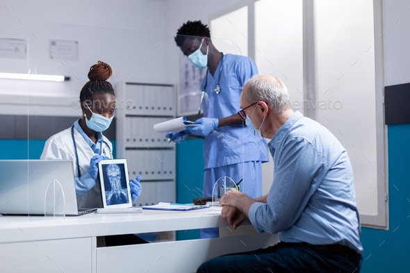 Black professional team of people explaining x ray
