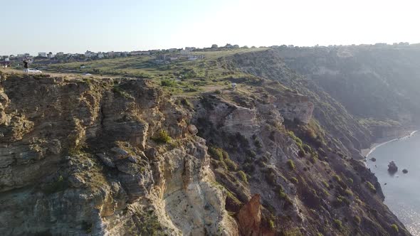 Drone footage of a cliff at morning landscape and sea