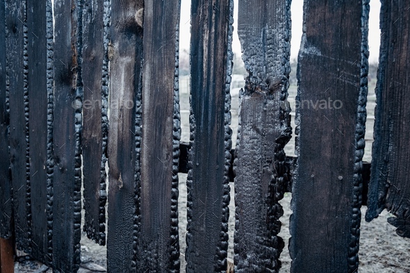 Burnt fence boards after a fire in a private house