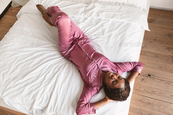 African Lady Lying With Eyes Closed Resting In Bedroom, Above-View