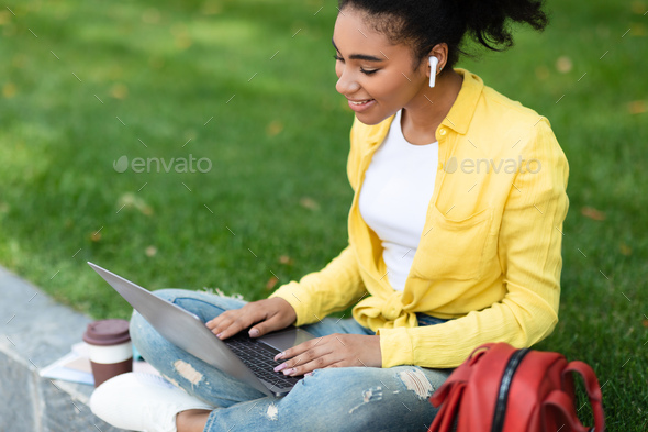 Black Student Female Video Calling Via Laptop Outside, High-Angle