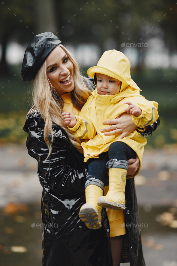 Funny kids in rain boots playing in a rain park Stock Photo by prostooleh