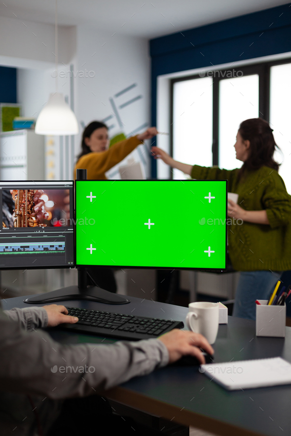 Video maker editing movie at pc with green screen