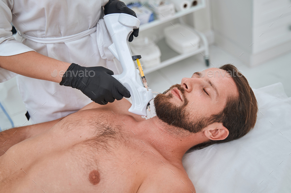 Patient getting an anti-wrinkle injection into his neck