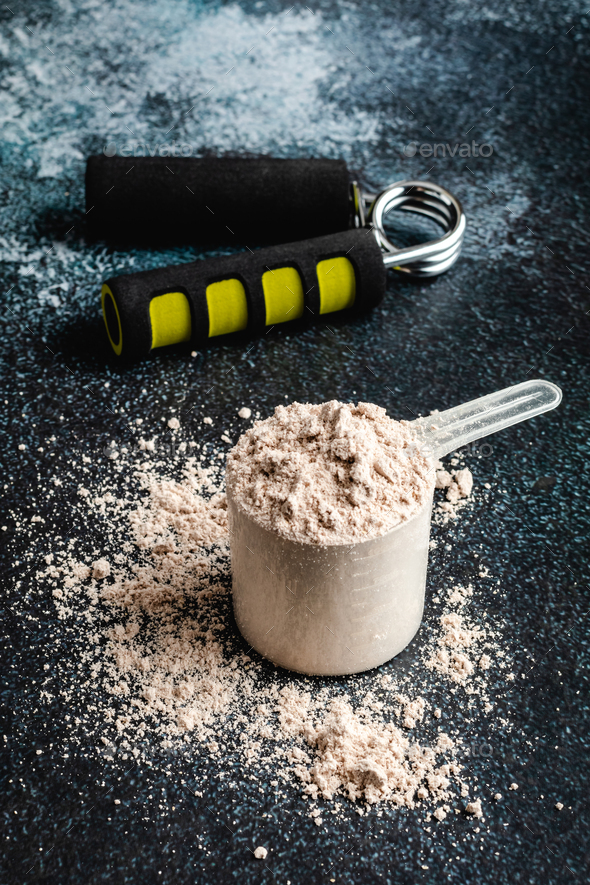 Scoops filled with protein powders for fitness nutrition to start training