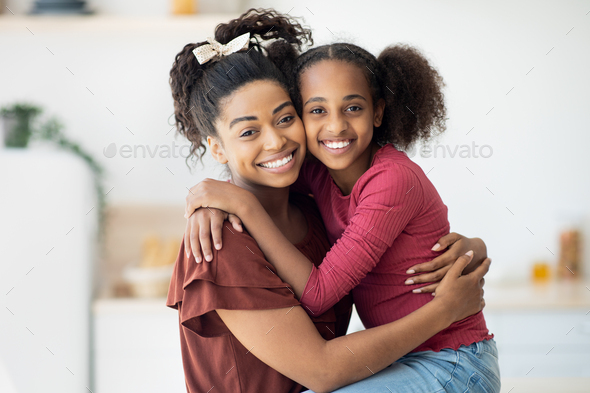 Closeup portrait of happy black mother and daughter - Stock Photo - Images