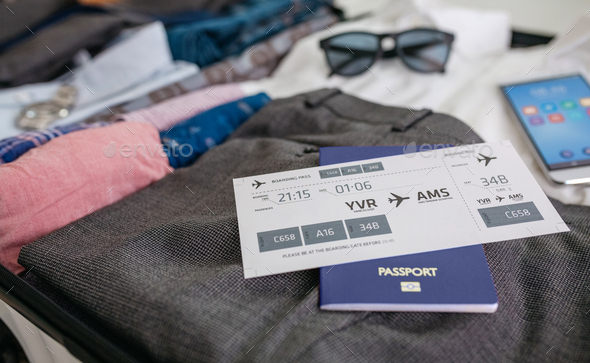 Boarding pass and passport in businessman's suitcase - Stock Photo - Images