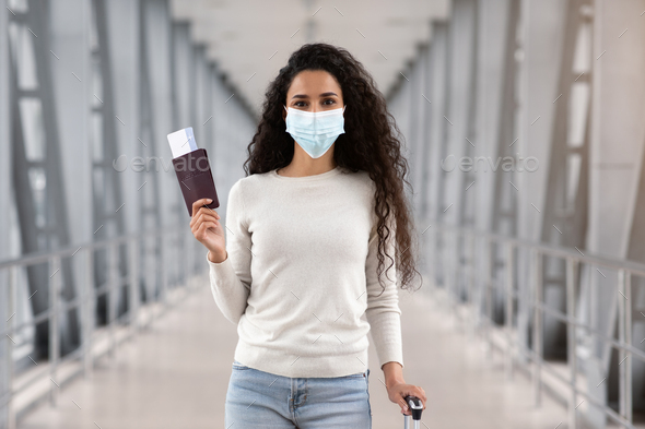 Pandemic Travels. Happy Young Woman In Protective Medical Mask Posing In Airport - Stock Photo - Images