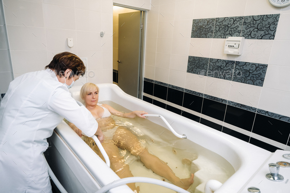 the procedure of underwater shower massage in the bathroom.Girl on the procedure of underwater