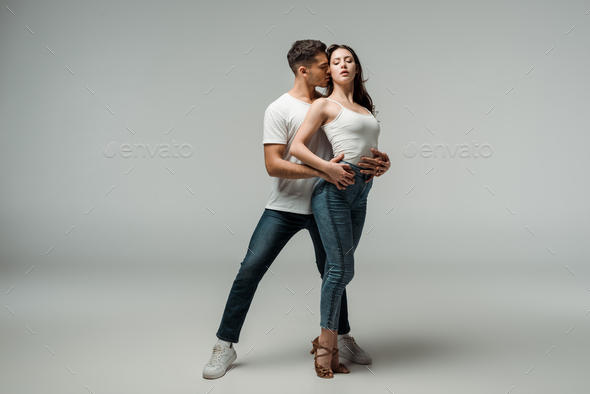 dancers with closed eyes dancing bachata on grey background - Stock Photo - Images
