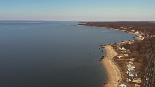 an aerial shot, looking down along an empty beach while it was quiet and peaceful on a sunny afterno alt