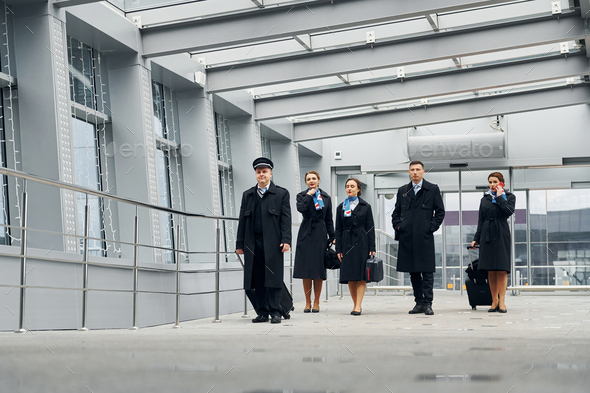 In uniform. Airplane crew in uniform is going to the work together - Stock Photo - Images