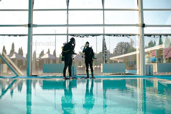 Woman and male instructor, course in diving school