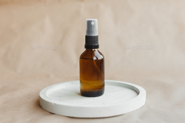 One cosmetic dark amber glass bottle on plaster stand. . Beauty blogging concept
