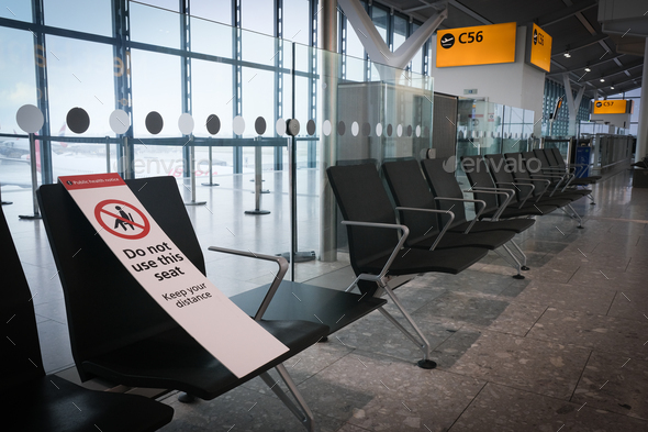 Social distance notice sign on airport terminal chairs. Safety measures from covid-19 pandemic