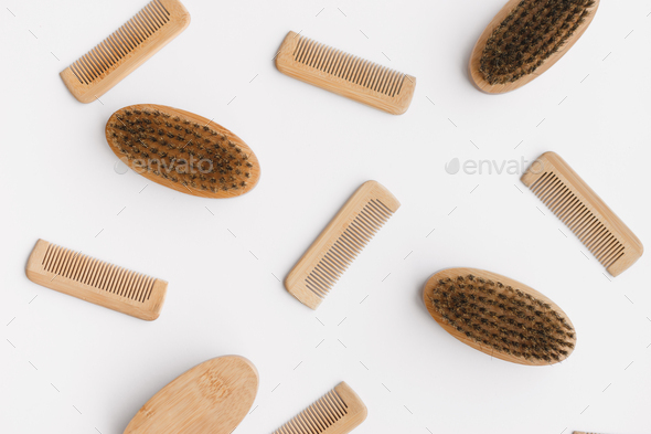 Wooden hair and beard combs flat lay on textured white background