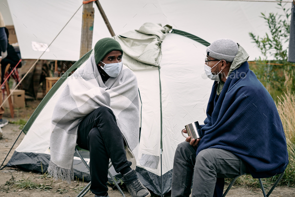 Migrants Sitting At Tent