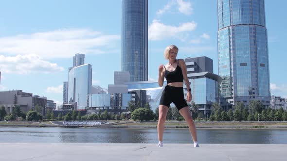 Woman dancing on street in city