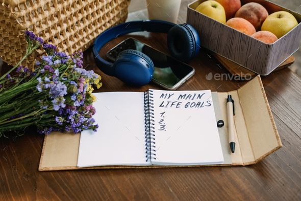 New Years Resolutions Life Goals list in open notebook on the table. Outdoor still life with My Life