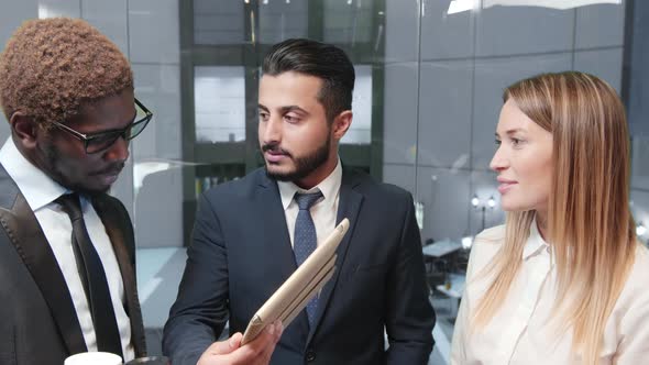 Businessmen in elevator with tablet computer