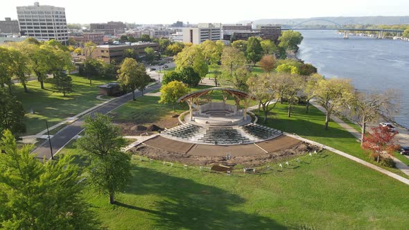 Pan out over park along Mississippi River. Construction continues on bandshell renovation.