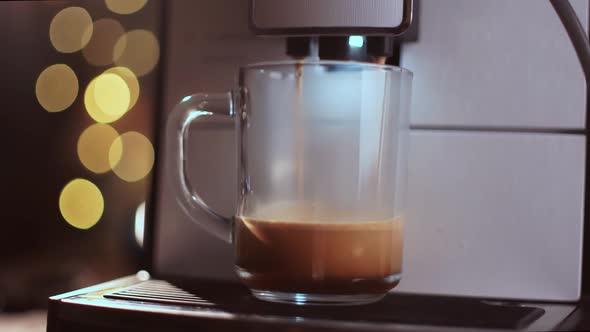 Pouring Coffee Stream From Professional Machine in Cup. Barista Making Double Espresso or Americano