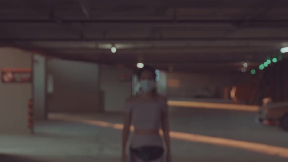 A Girl in a Medical Mask Comes Up To the Camera and Gets Into Focus alt