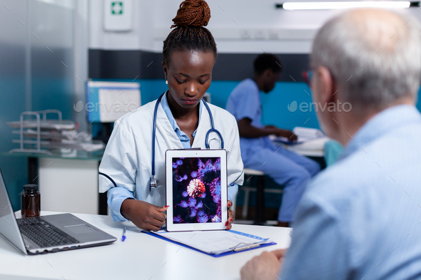 African american medic holding virus animation on tablet