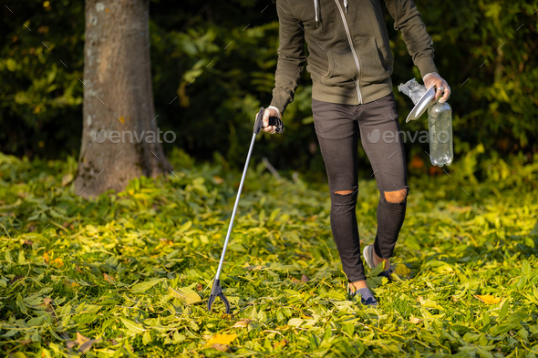 Low section of volunteer conserving environment from pollution and plastic - Stock Photo - Images