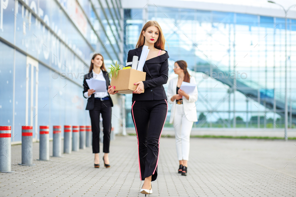 Sad woman fired from a large corporation. Concept for business, unemployment, labor exchange - Stock Photo - Images