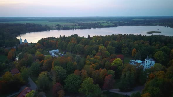 Stameriena Palace, Stameriena Lake at Sunset Aerial View in Autumn, Orthodox Church in Background. alt