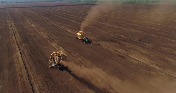 Peat Harvesting Machinery Extracting Peat Turf in Drained Bog Aerial View