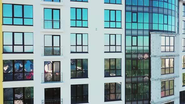 Many windows on new apartment building facade under construction. Real estate development alt