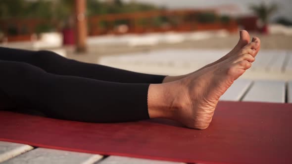 Athletic Woman Practicing Yoga on Mat on the Beach Performing Yoga Elements Upwards Plank alt