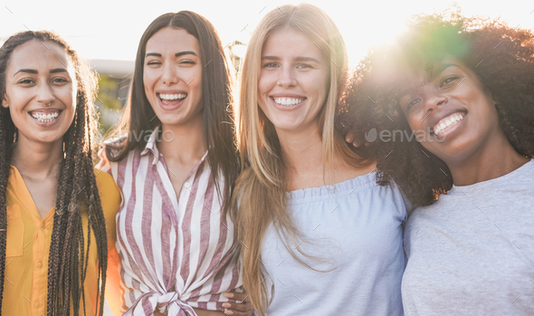 Beautiful multiracial girls looking and smiling on camera - Young women with different skin color - Stock Photo - Images