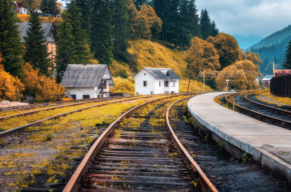 Railway station and white house in mountain village at sunset - Stock Photo - Images
