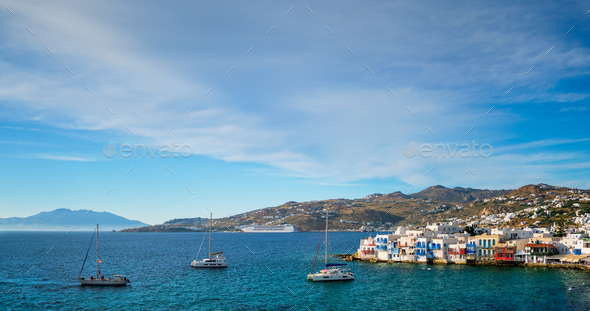 Sunset in Mykonos, Greece, with cruise ship and yachts in the harbor - Stock Photo - Images