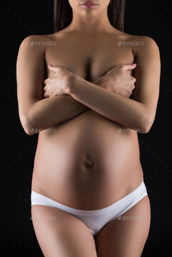 cropped view of naked pregnant woman posing in white underwear, isolated on  black Stock Photo by LightFieldStudios