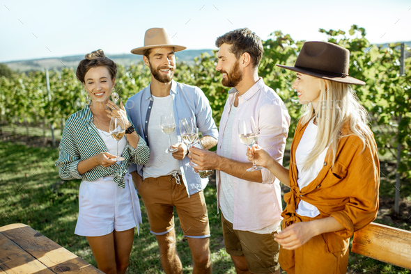 Friends tasting wine on the vineyard
