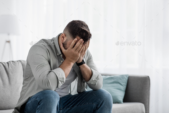 Shame despair, portrait of sad man suffers from headache, stress, depression - Stock Photo - Images