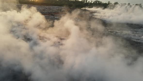 Aerial view fire burning at garbage dump site alt