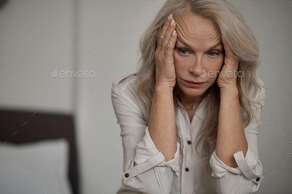 Despondent blonde mature woman suffering from loneliness