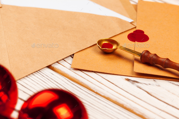 Close up of a Christmas letter with wax seal stamp on wooden table