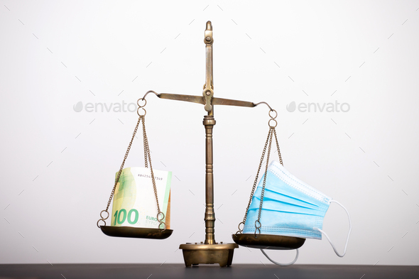 Medical mask with dollar money on scales - Stock Photo - Images