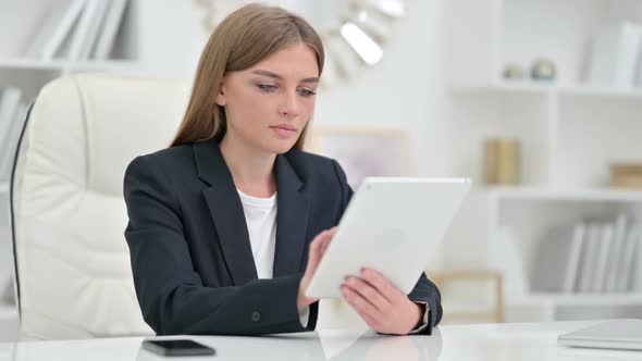 Serious Professional Businesswoman Using Tablet in Office alt